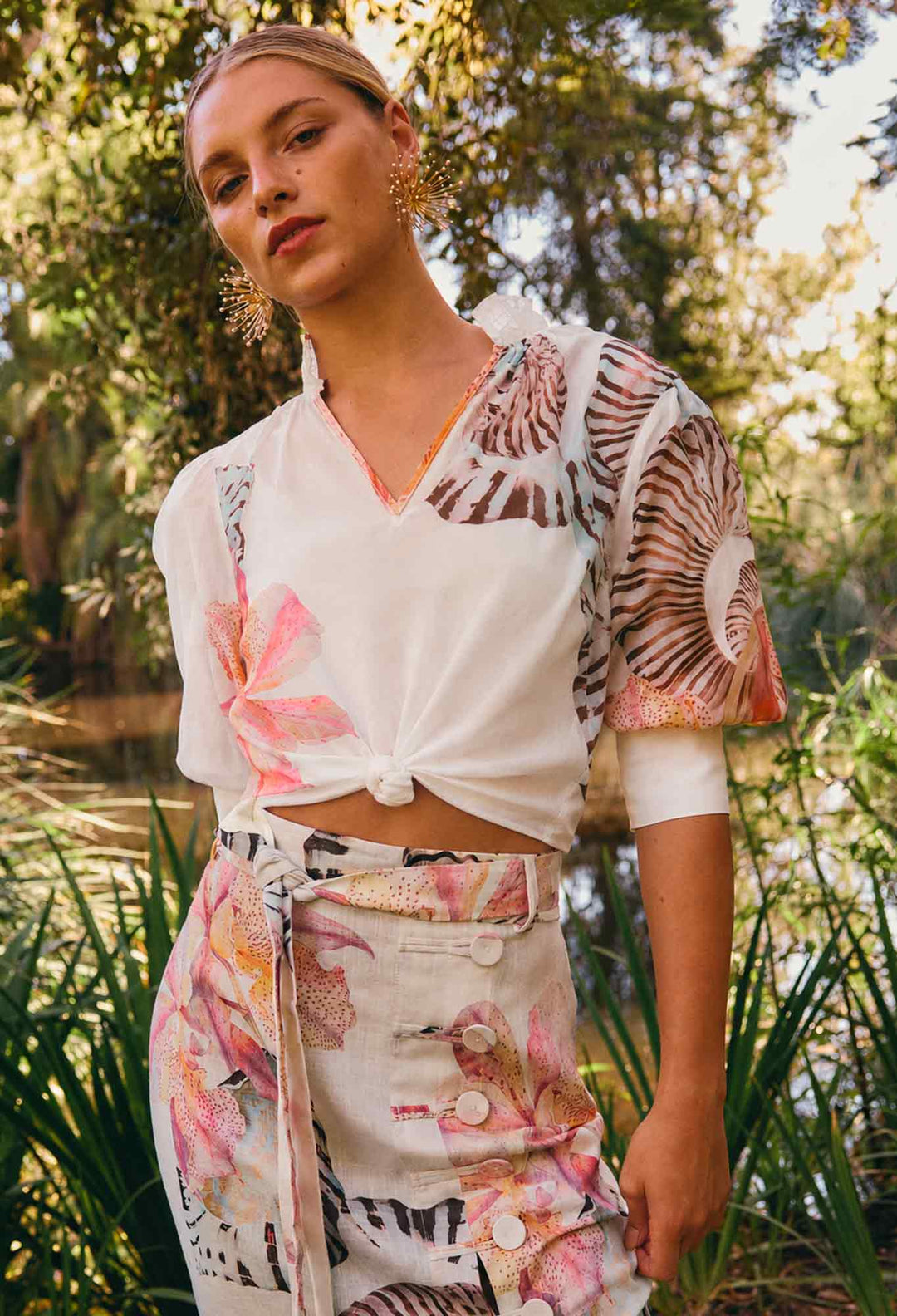 Woman wearing a colourful outfit with floral patterns in a natural setting